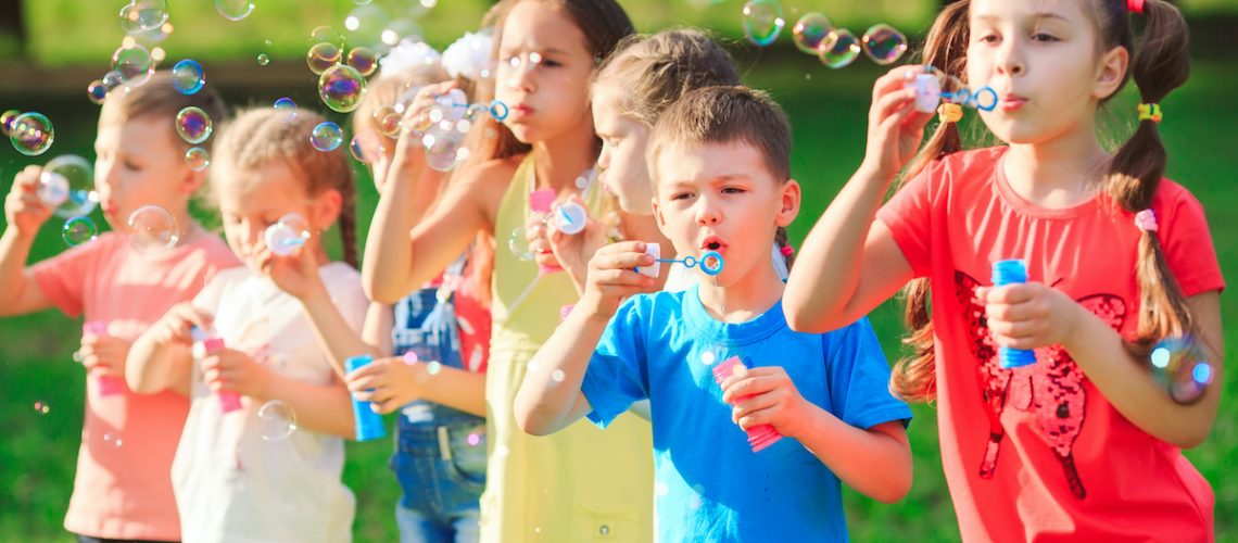 Group of children blowing soap bubbles
